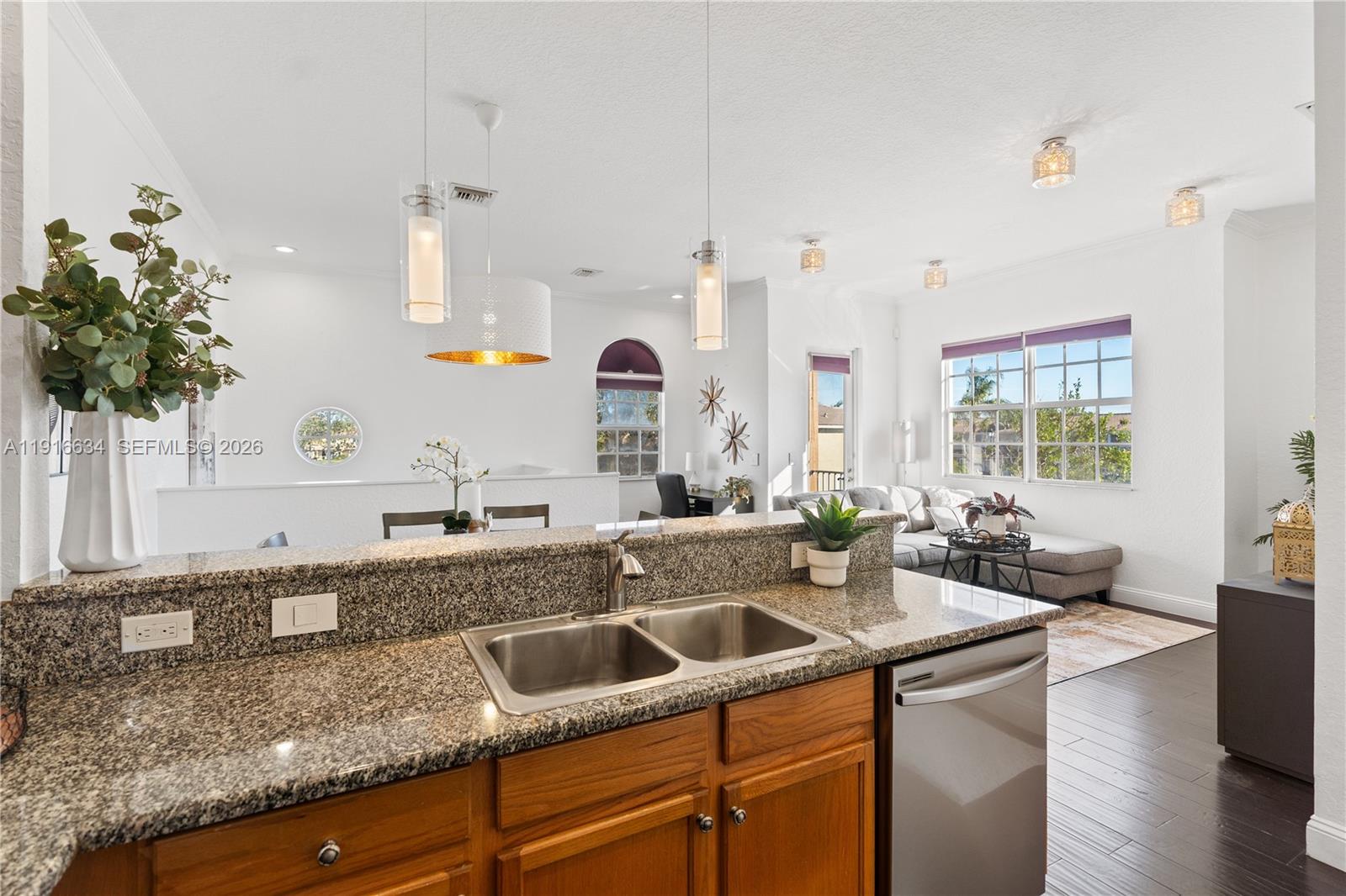 5850 Hampton Hills Boulevard, Unit 5850 Tamarac, FL 33321 - Photo 4 of 22 a kitchen with stainless steel appliances granite countertop a sink a counter space and cabinets