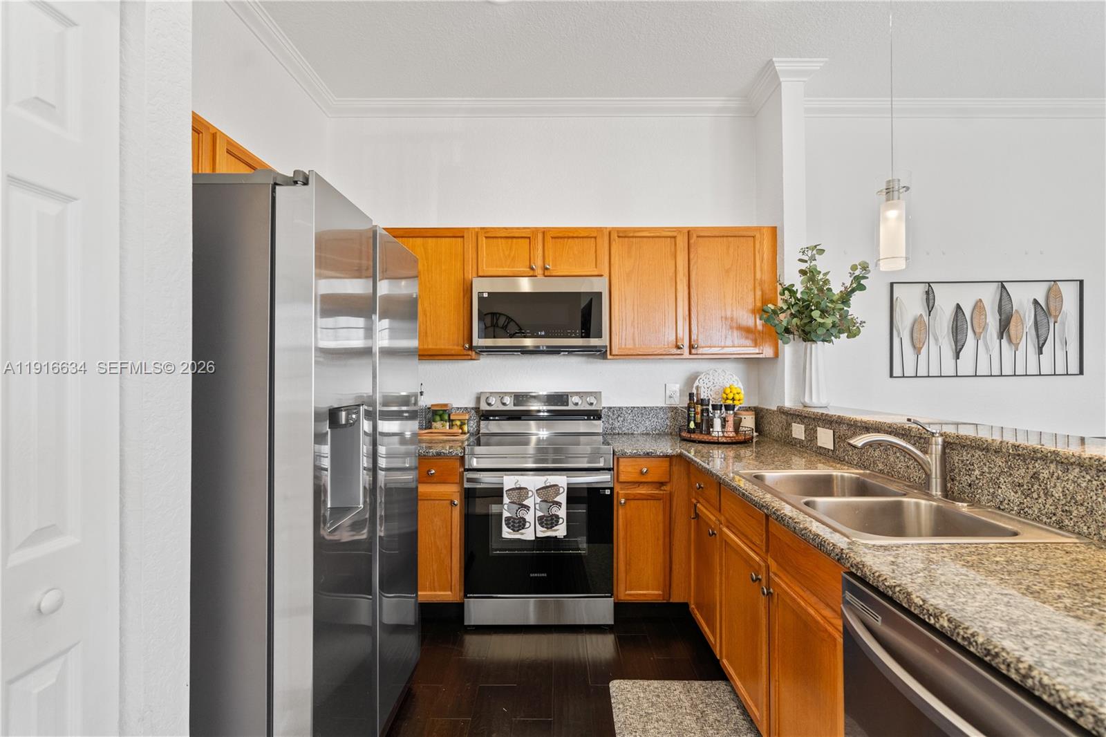 5850 Hampton Hills Boulevard, Unit 5850 Tamarac, FL 33321 - Photo 5 of 22 a kitchen with stainless steel appliances granite countertop a sink stove and refrigerator