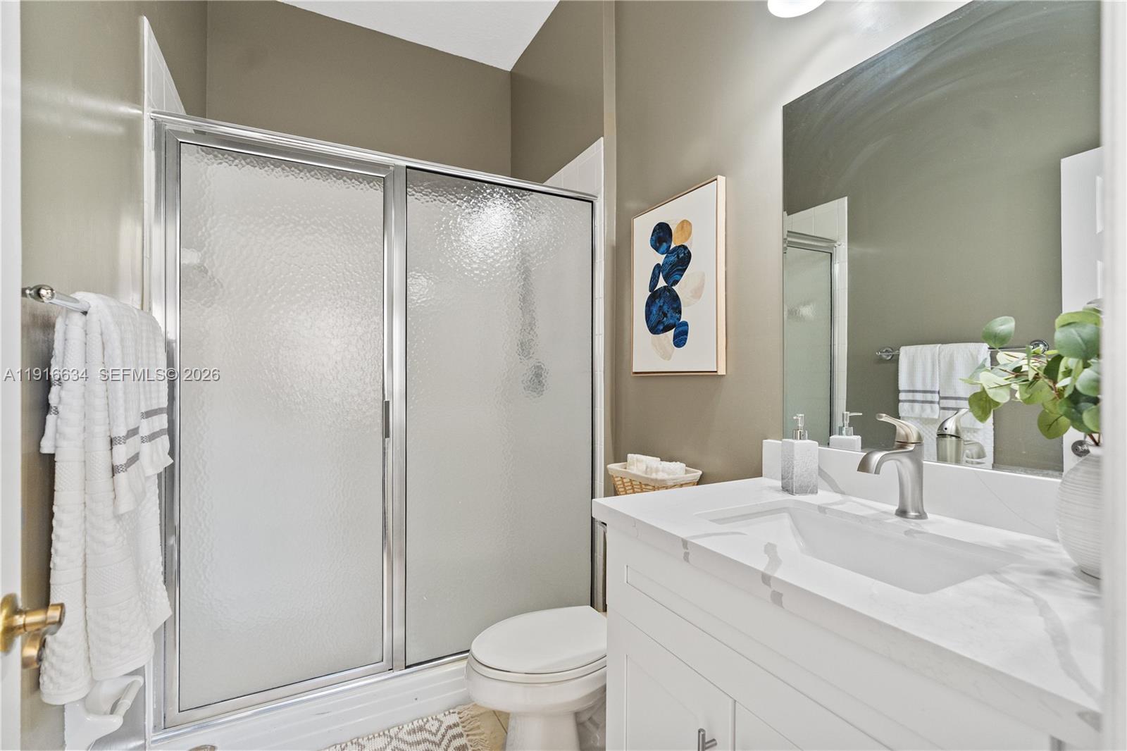 5850 Hampton Hills Boulevard, Unit 5850 Tamarac, FL 33321 - Photo 9 of 22 a bathroom with a sink toilet and shower