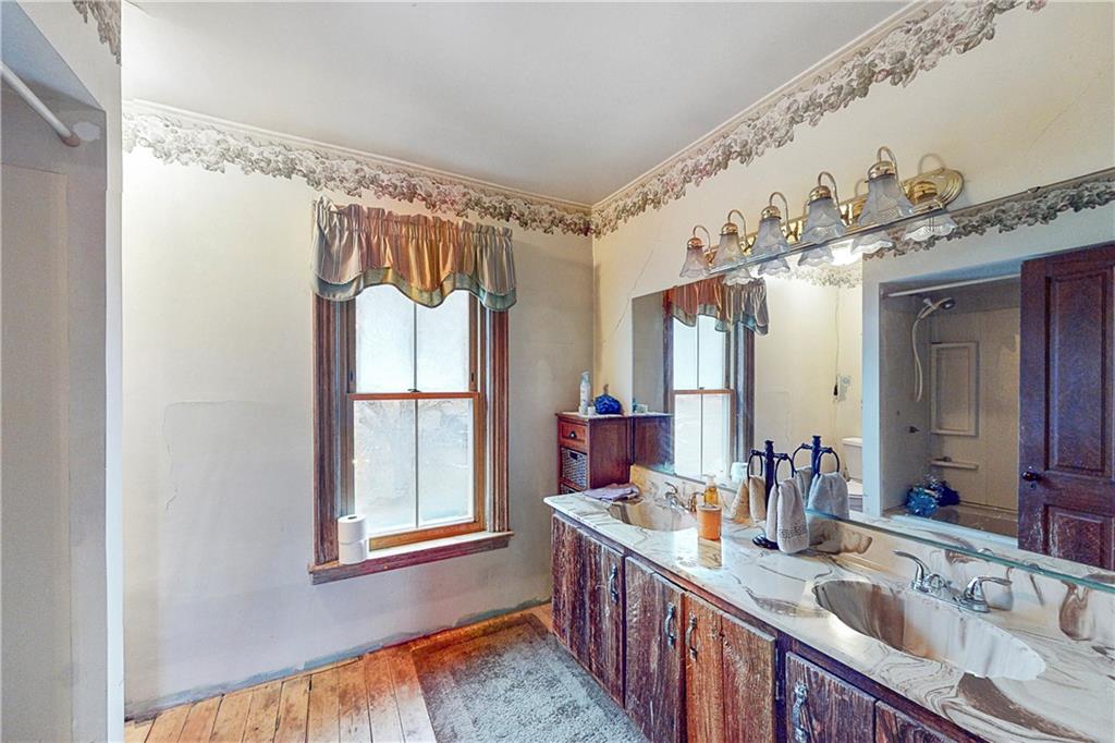 181 Rea Road Avella, PA 15312 - Photo 16 of 22 a bathroom with a granite countertop sink mirror and a shower