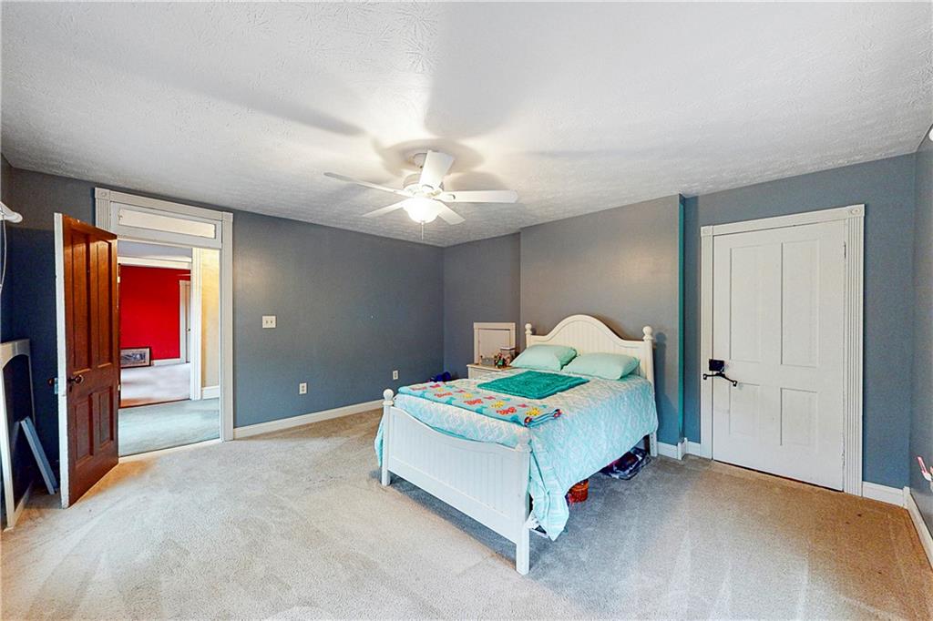 181 Rea Road Avella, PA 15312 - Photo 19 of 22 a bedroom with a bed and a chandelier