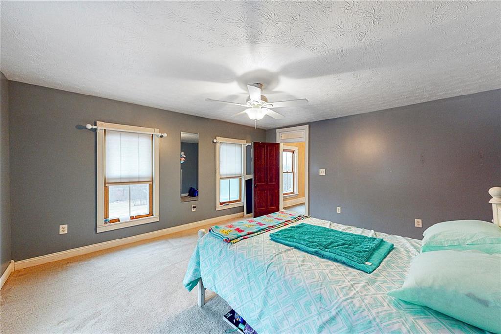 181 Rea Road Avella, PA 15312 - Photo 20 of 22 a bedroom with a large bed and a chandelier fan