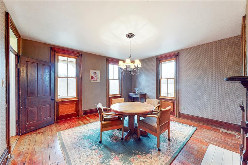 181 Rea Road Avella, PA 15312 - Photo 9 of 22 a dining room with wooden floor a chandelier a wooden table and chairs