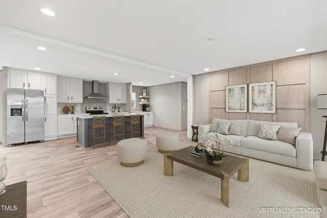 a living room with furniture and kitchen view