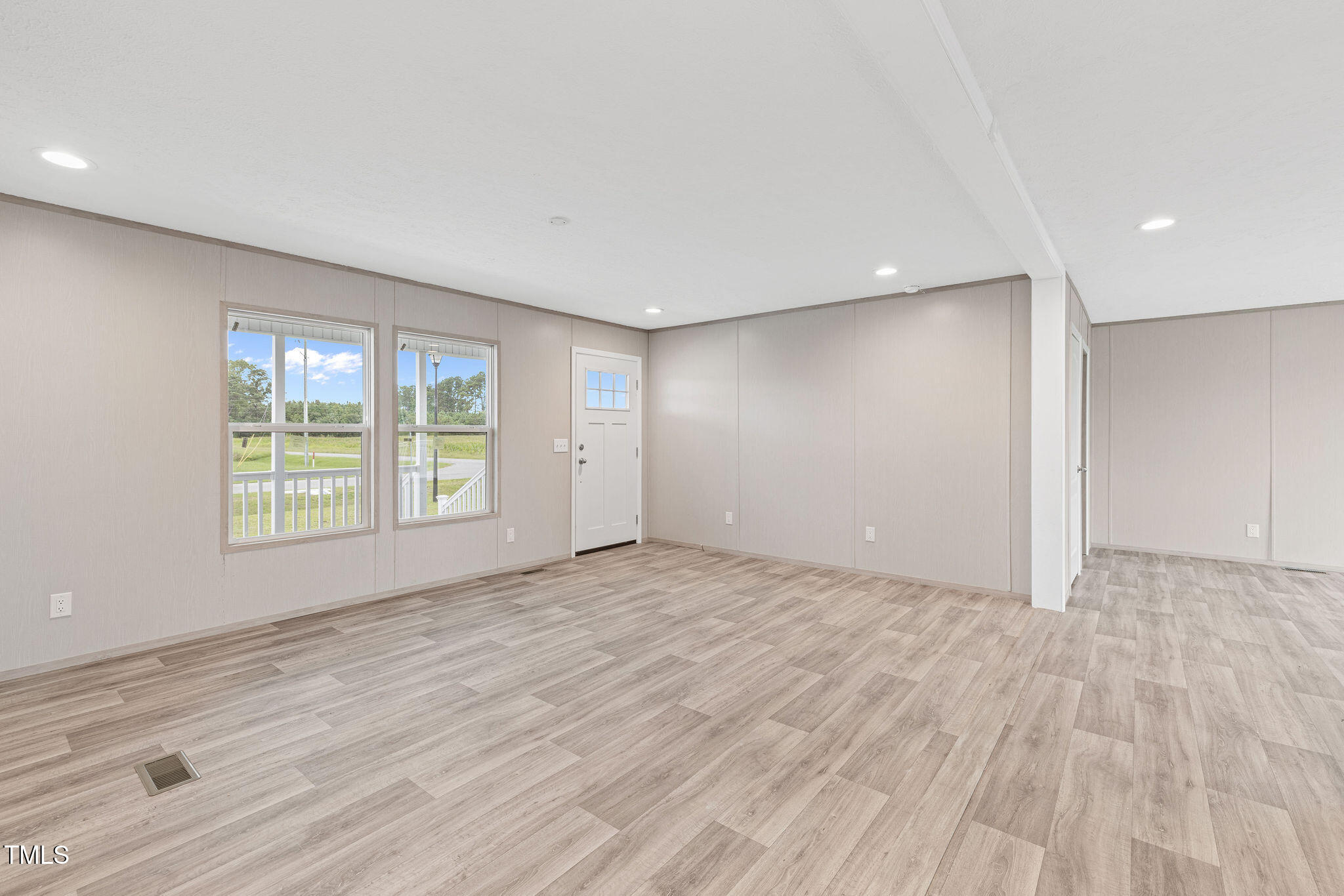 17 Stardust Lane Selma, NC 27576 - Photo 16 of 27 an empty room with wooden floor and windows