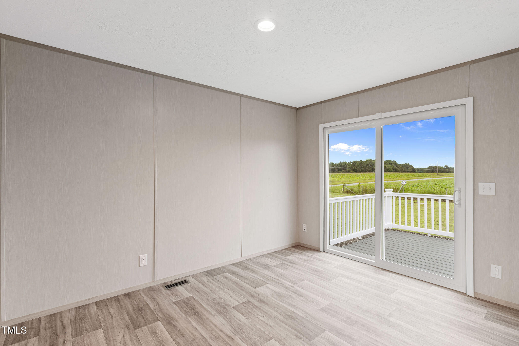 17 Stardust Lane Selma, NC 27576 - Photo 19 of 27 a view of empty room with wooden floor and floor to ceiling window