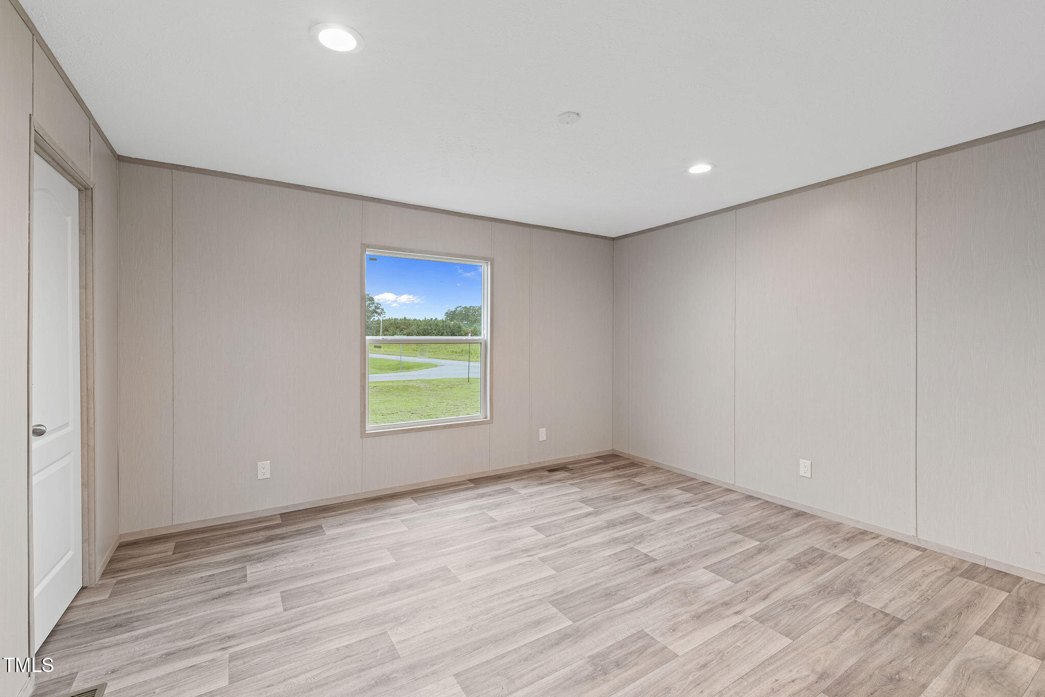 17 Stardust Lane Selma, NC 27576 - Photo 21 of 27 a view of an empty room with wooden floor and a window