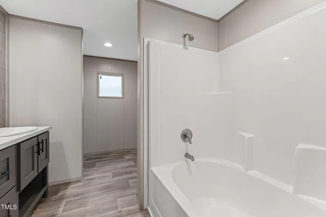 a bathroom with a granite countertop sink a toilet and shower
