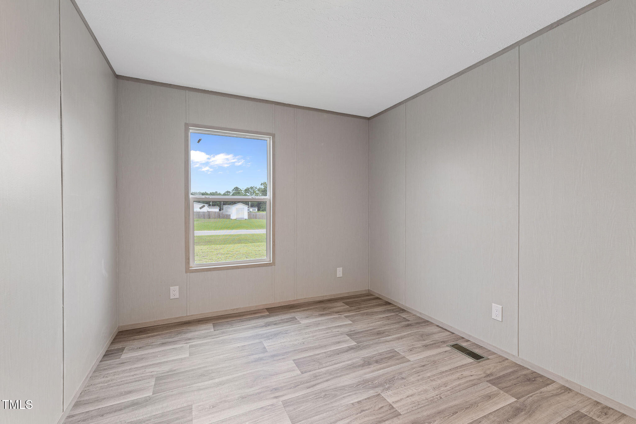 17 Stardust Lane Selma, NC 27576 - Photo 24 of 27 a view of an empty room with wooden floor and a window
