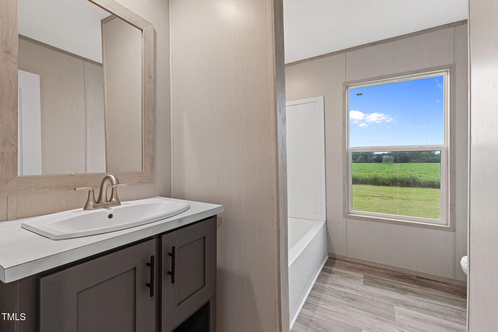 17 Stardust Lane Selma, NC 27576 - Photo 25 of 27 a bathroom with a sink and a mirror