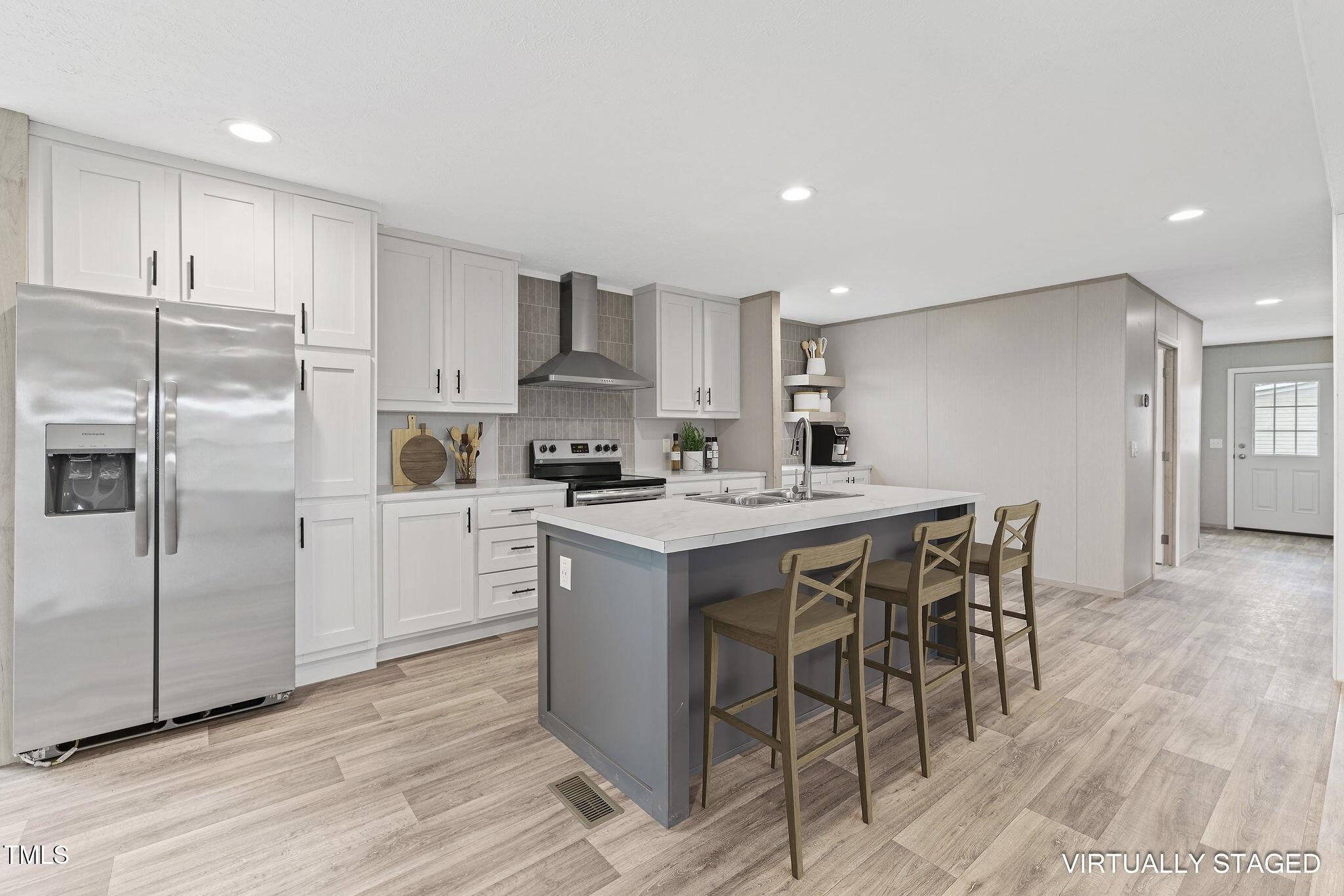 17 Stardust Lane Selma, NC 27576 - Photo 6 of 27 a kitchen with a sink a refrigerator and cabinets
