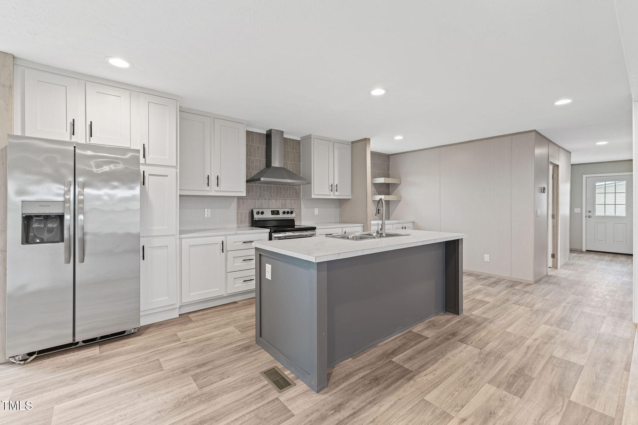 17 Stardust Lane Selma, NC 27576 - Photo 7 of 27 a kitchen with stainless steel appliances granite countertop a white stove top oven and refrigerator