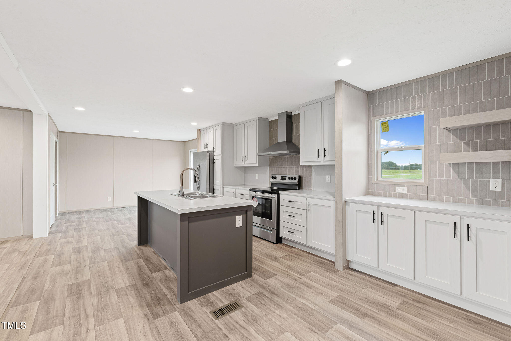 17 Stardust Lane Selma, NC 27576 - Photo 9 of 27 a kitchen with stainless steel appliances granite countertop a sink stove and refrigerator