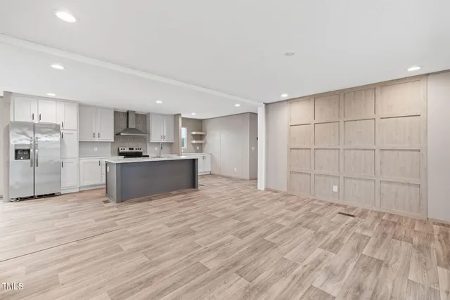 a view of a kitchen with a sink and a refrigerator