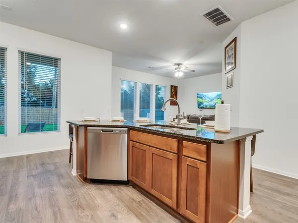 a kitchen with stainless steel appliances granite countertop a stove a microwave and cabinets