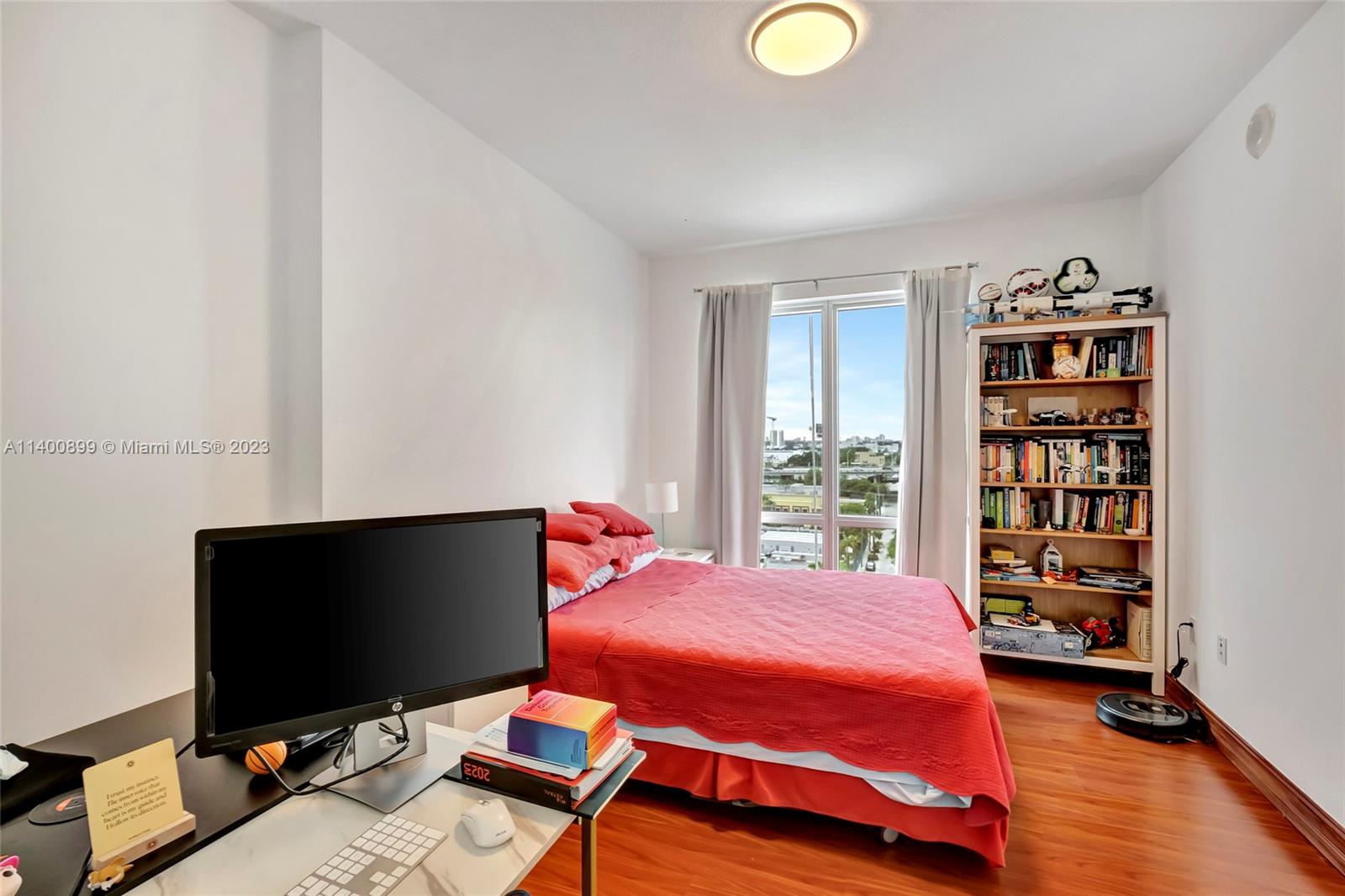 185 Southwest 7th Street, Unit 901 Miami, FL 33130 - Photo 13 of 35 a bedroom with a bed and a bookshelf