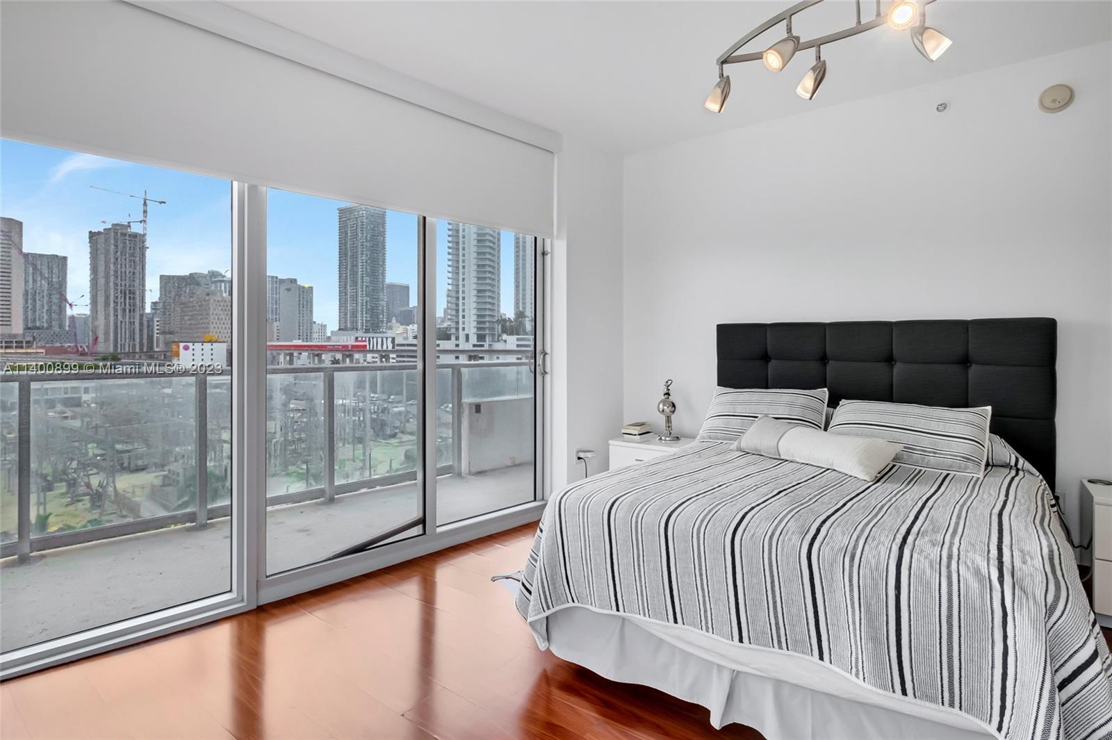 185 Southwest 7th Street, Unit 901 Miami, FL 33130 - Photo 18 of 35 a bedroom with a large bed and a large window