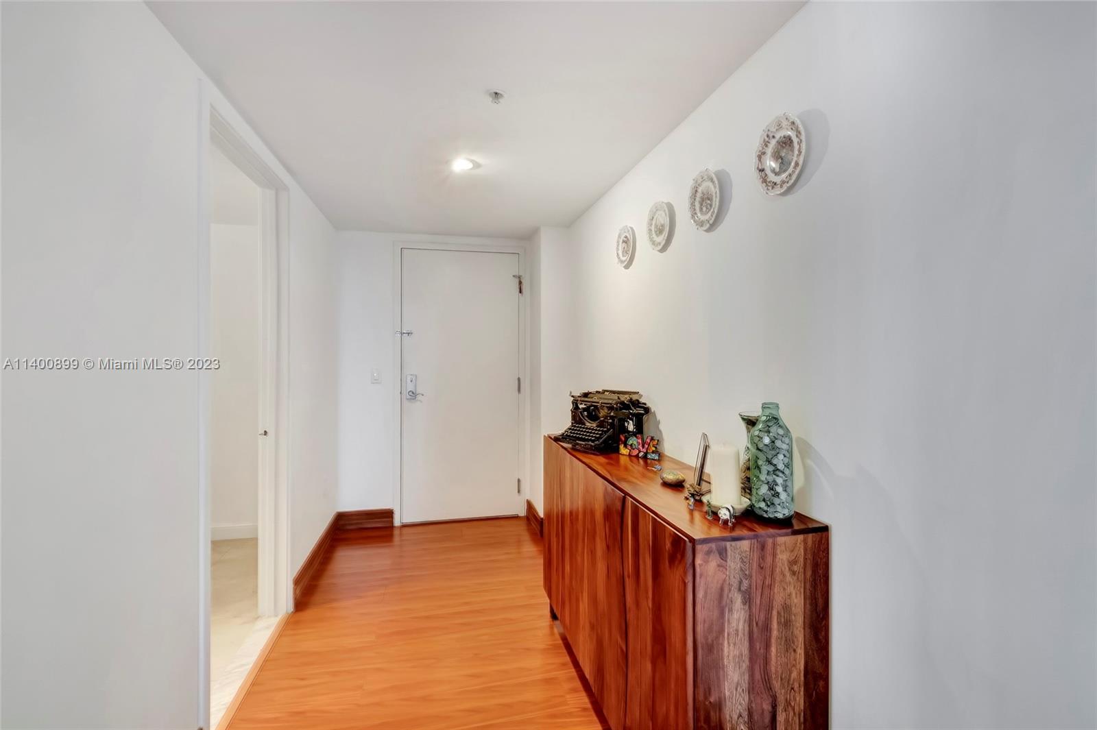 185 Southwest 7th Street, Unit 901 Miami, FL 33130 - Photo 2 of 35 a view of a hallway with wooden floor