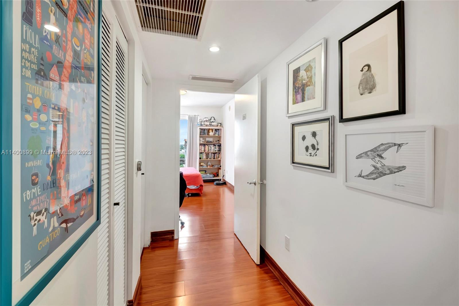 185 Southwest 7th Street, Unit 901 Miami, FL 33130 - Photo 5 of 35 a hallway with painting on the wall and a window