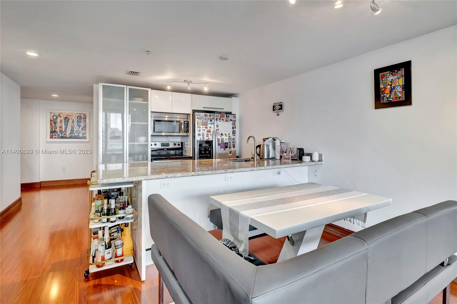 185 Southwest 7th Street, Unit 901 Miami, FL 33130 - Photo 8 of 35 a living room with stainless steel appliances kitchen island granite countertop furniture and a wooden floor