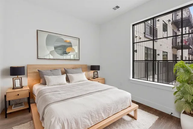 a bedroom with a bed and a window