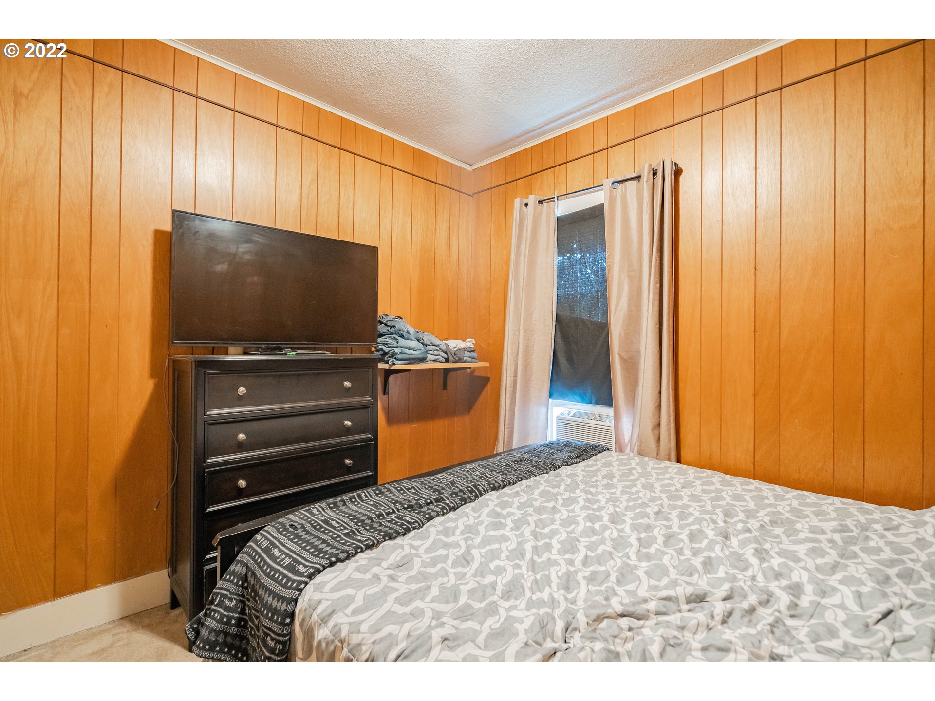 111 South 3rd Avenue Ridgefield, WA 98642 - Photo 21 of 32 a bedroom with a bed and a flat screen tv