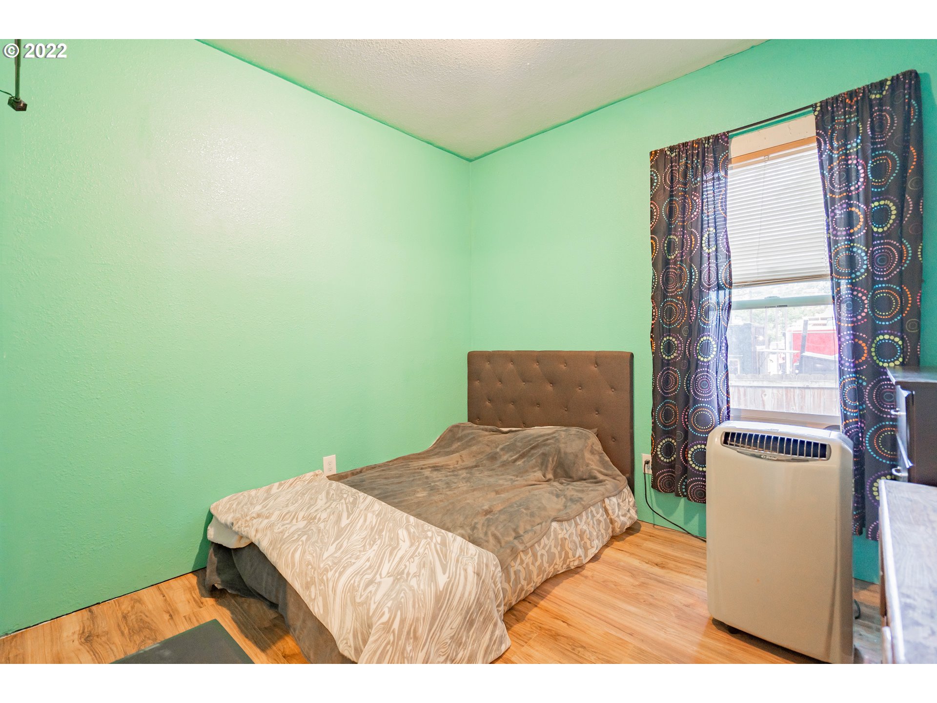 111 South 3rd Avenue Ridgefield, WA 98642 - Photo 23 of 32 a bedroom with a bed and a window