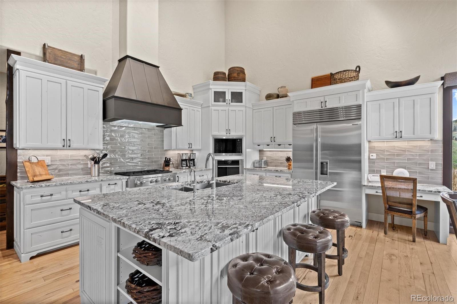 1733 Swede Gulch Road Evergreen, CO 80439 - Photo 17 of 50 a kitchen with stainless steel appliances granite countertop a stove and a refrigerator