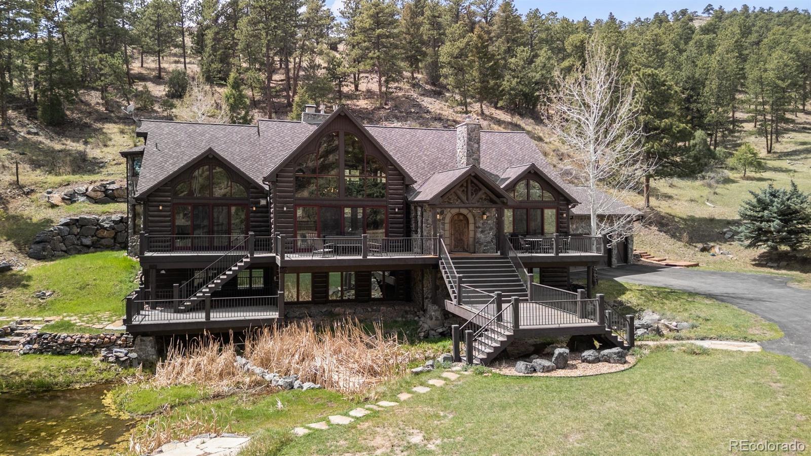 1733 Swede Gulch Road Evergreen, CO 80439 - Photo 2 of 50 a front view of a house with a yard