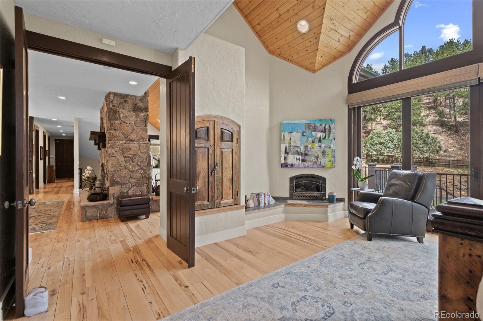 1733 Swede Gulch Road Evergreen, CO 80439 - Photo 25 of 50 a living room with furniture and a fireplace