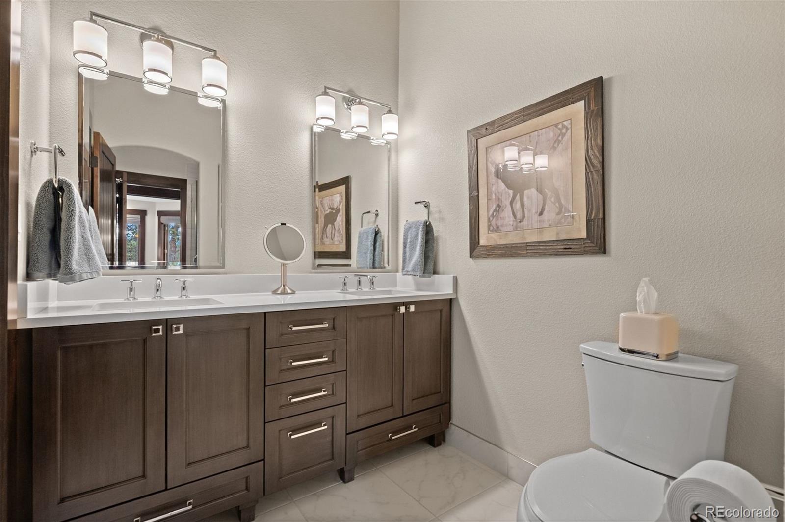1733 Swede Gulch Road Evergreen, CO 80439 - Photo 33 of 50 a bathroom with a toilet a sink and mirror