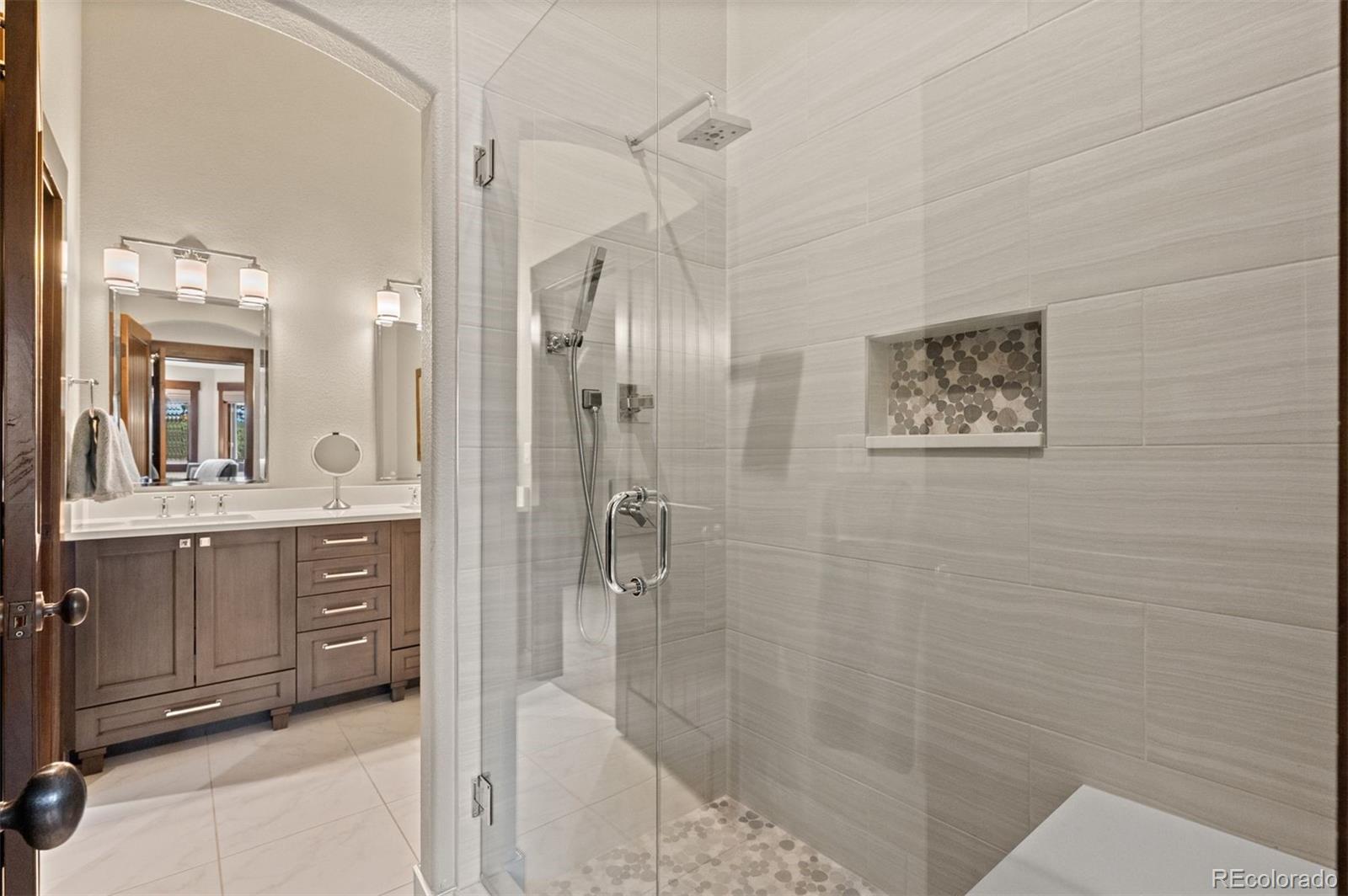 1733 Swede Gulch Road Evergreen, CO 80439 - Photo 34 of 50 a bathroom with a shower a sink and a mirror