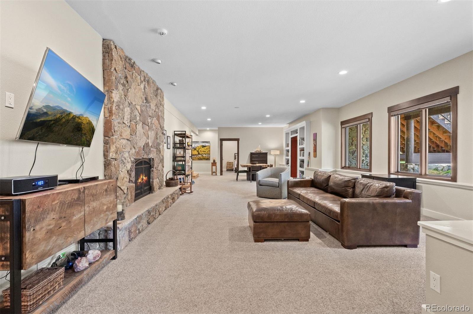 1733 Swede Gulch Road Evergreen, CO 80439 - Photo 38 of 50 a living room with furniture and a flat screen tv