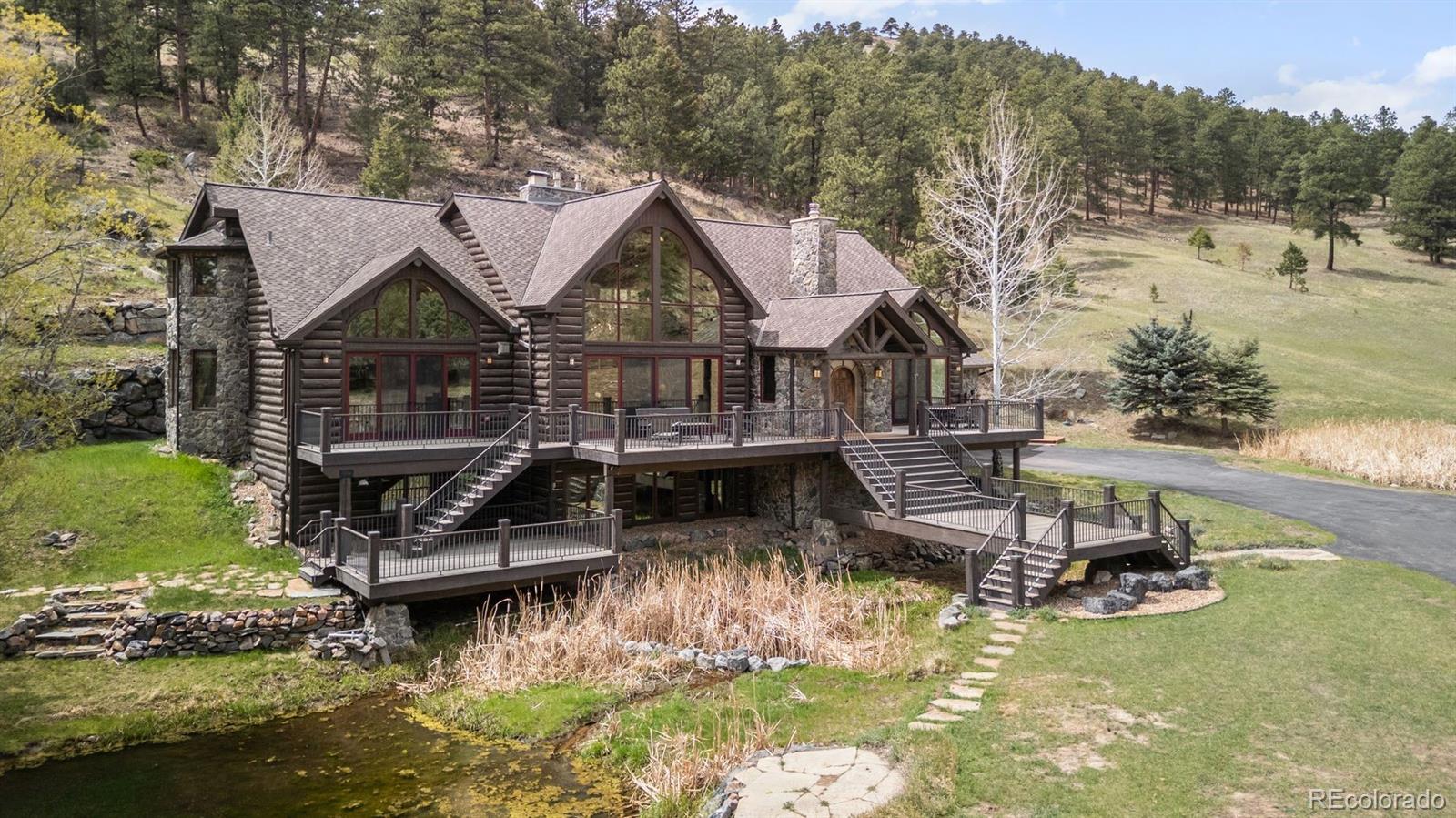 1733 Swede Gulch Road Evergreen, CO 80439 - Photo 4 of 50 a small house with lots of trees in the background