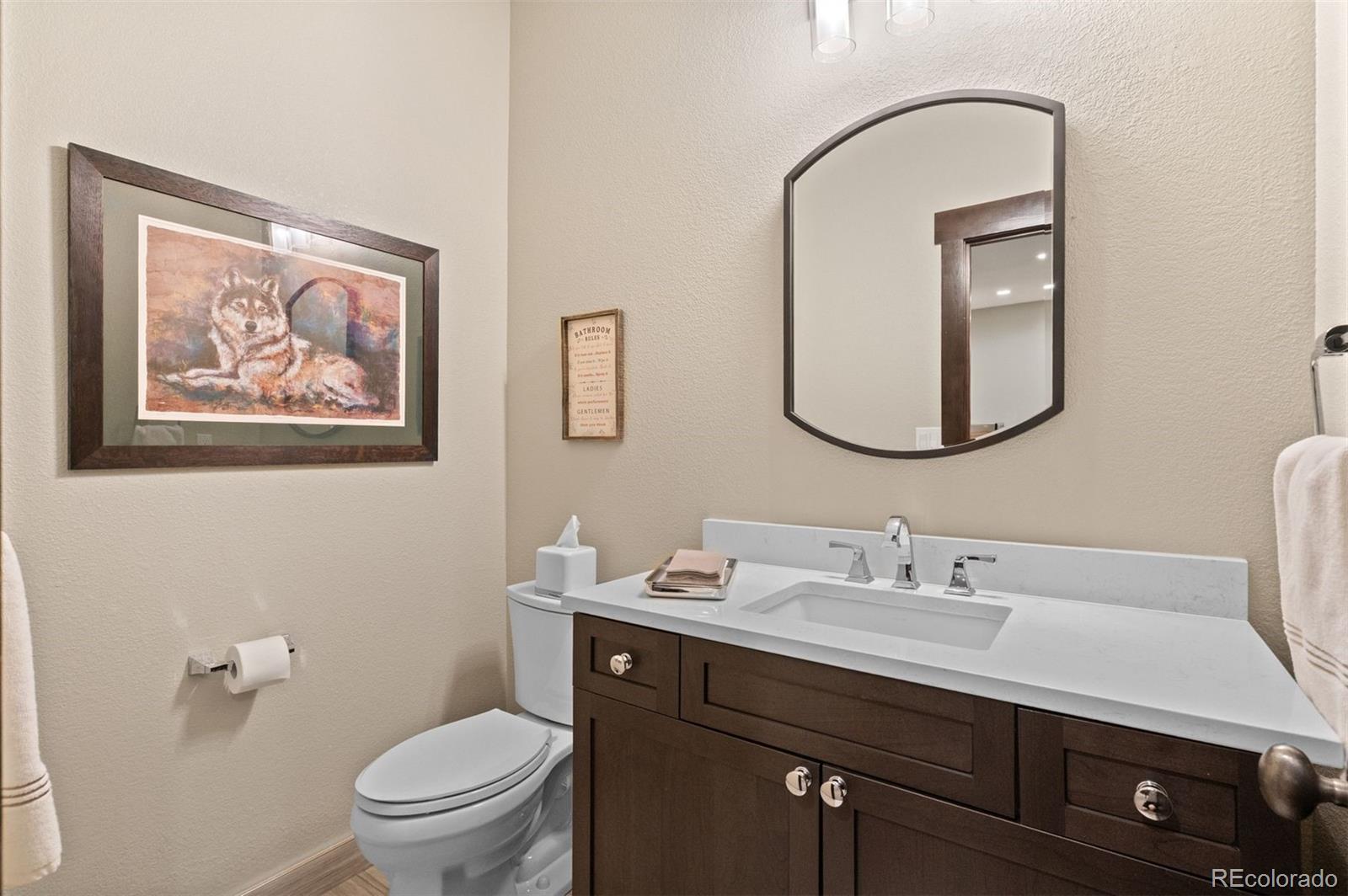 1733 Swede Gulch Road Evergreen, CO 80439 - Photo 41 of 50 a bathroom with a toilet a sink and mirror