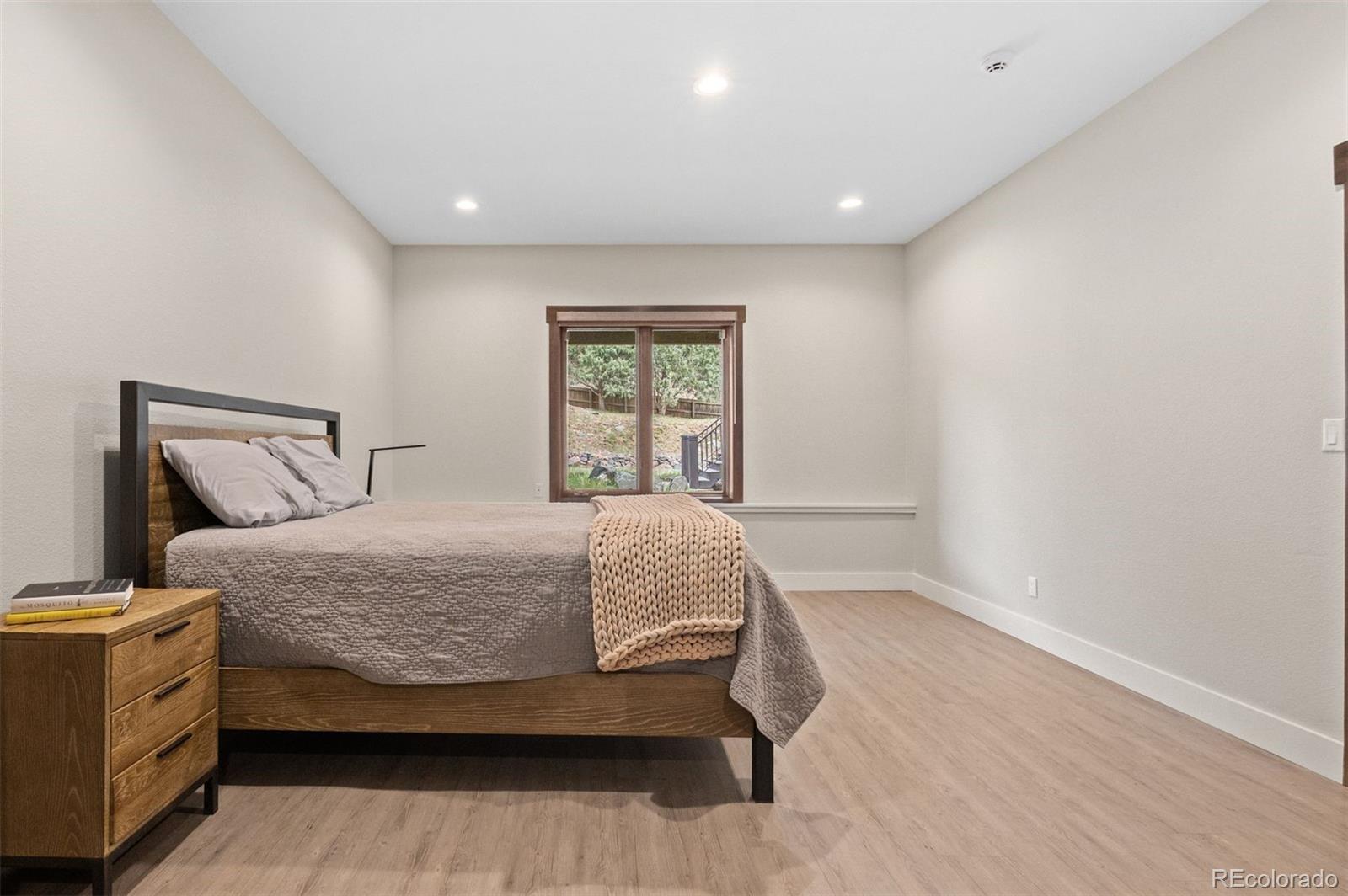 1733 Swede Gulch Road Evergreen, CO 80439 - Photo 42 of 50 a bedroom with a bed and a window