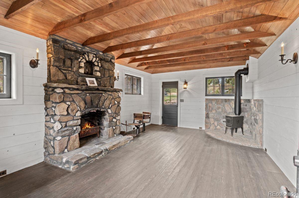 1733 Swede Gulch Road Evergreen, CO 80439 - Photo 48 of 50 a view of a livingroom with furniture and a fireplace
