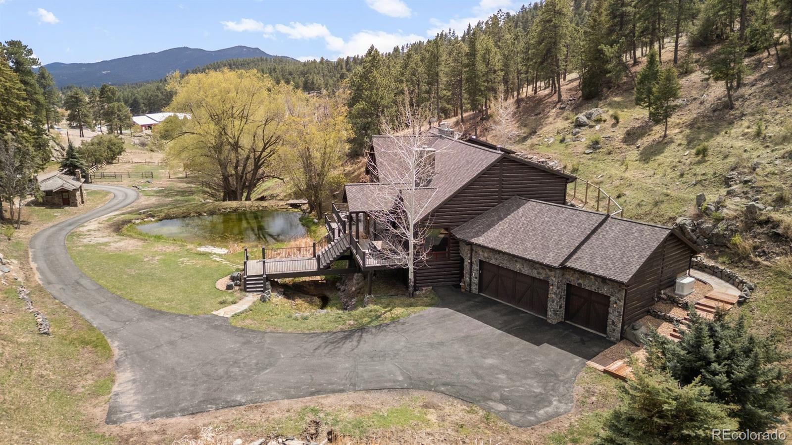 1733 Swede Gulch Road Evergreen, CO 80439 - Photo 6 of 50 a view of a house with a yard