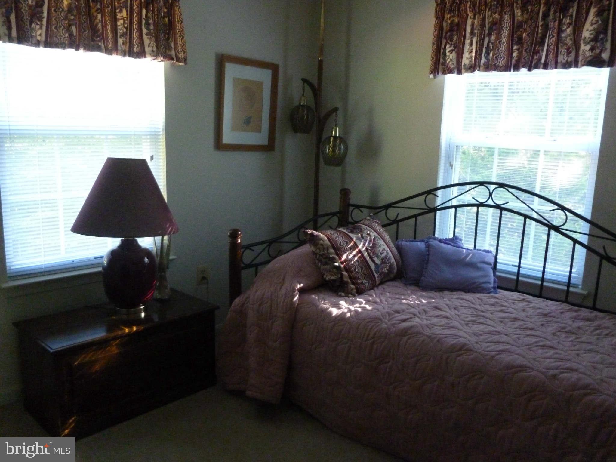 670 Small Reward Road Huntingtown, MD 20639 - Photo 19 of 26 a bed sitting in a bedroom next to a window