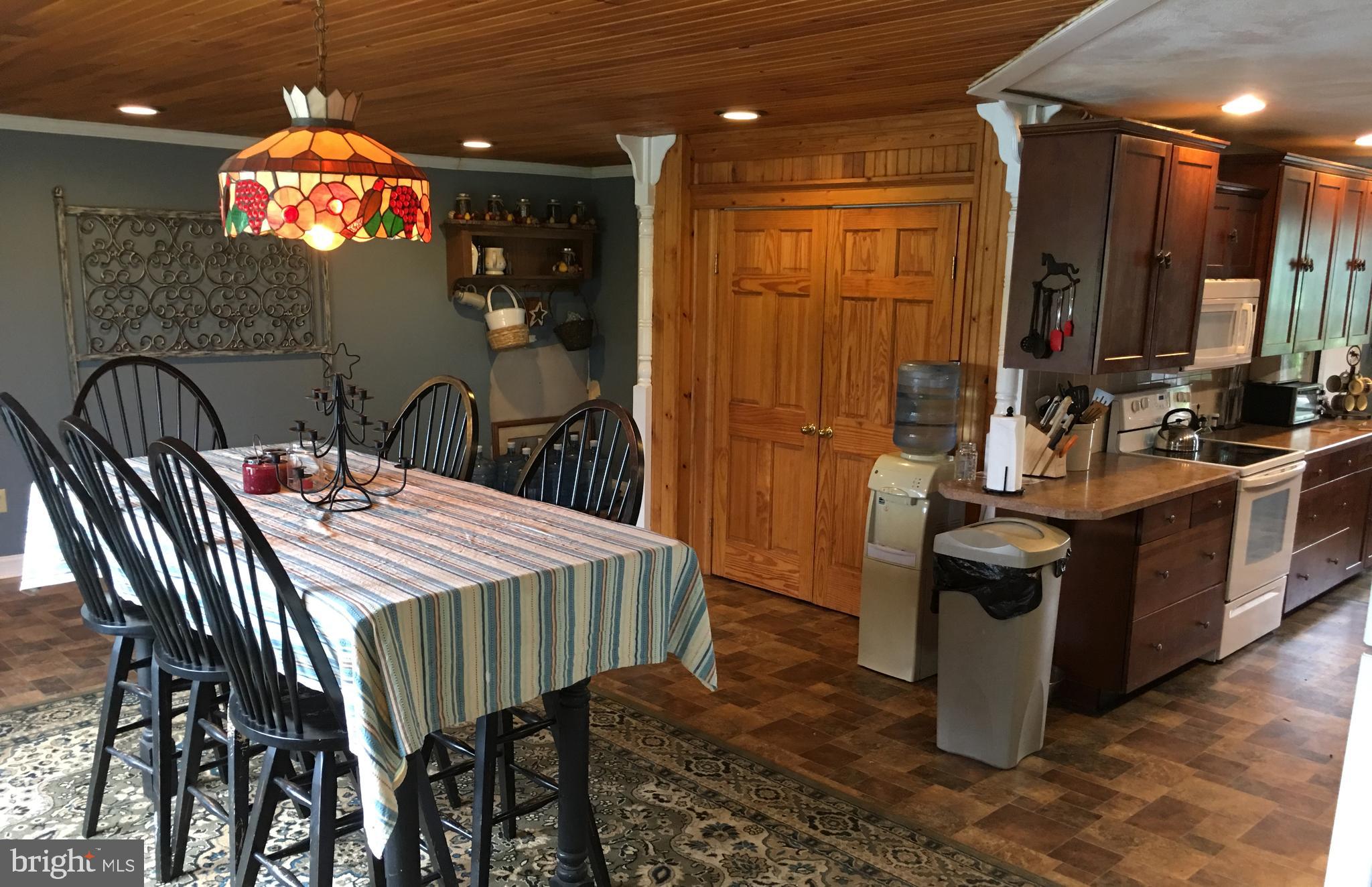 174 West Tomlin Station Road Mickleton, NJ 08056 - Photo 2 of 41 a dining room with a table chairs and a kitchen view