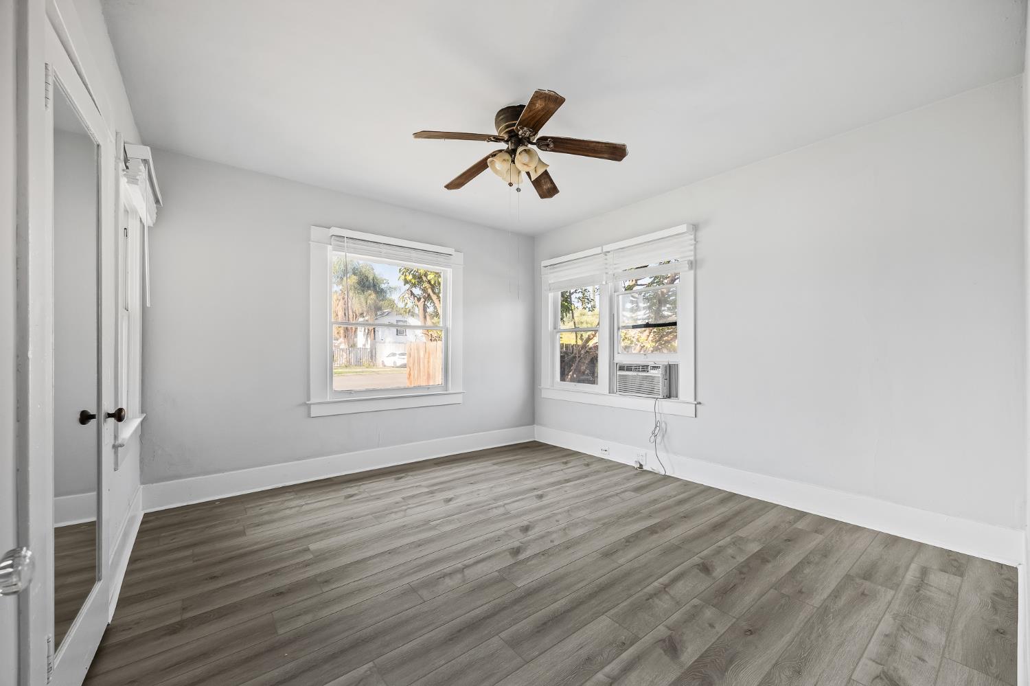 4001 East Balch Avenue Fresno, CA 93702 - Photo 13 of 22 a view of empty room with wooden floor and fan