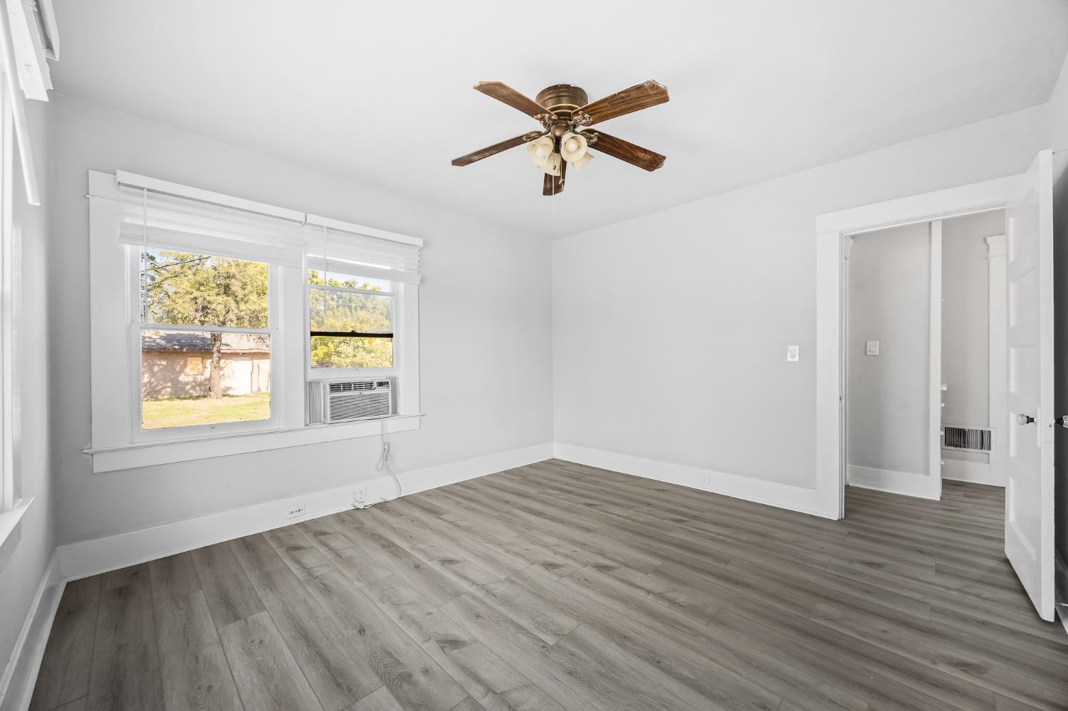 4001 East Balch Avenue Fresno, CA 93702 - Photo 14 of 22 wooden floor in an empty room with a window