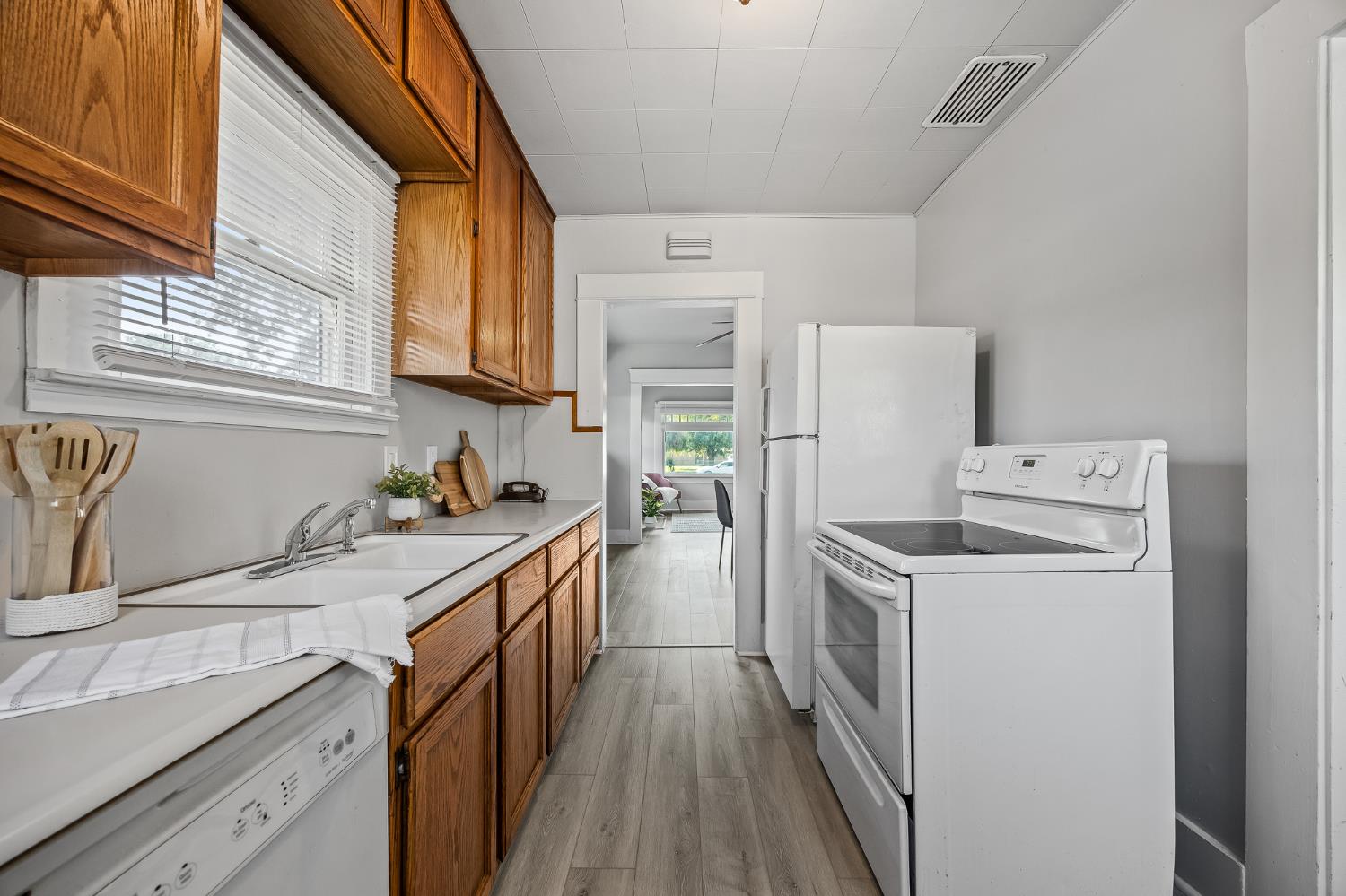 4001 East Balch Avenue Fresno, CA 93702 - Photo 8 of 22 a kitchen with a sink a stove top oven and refrigerator