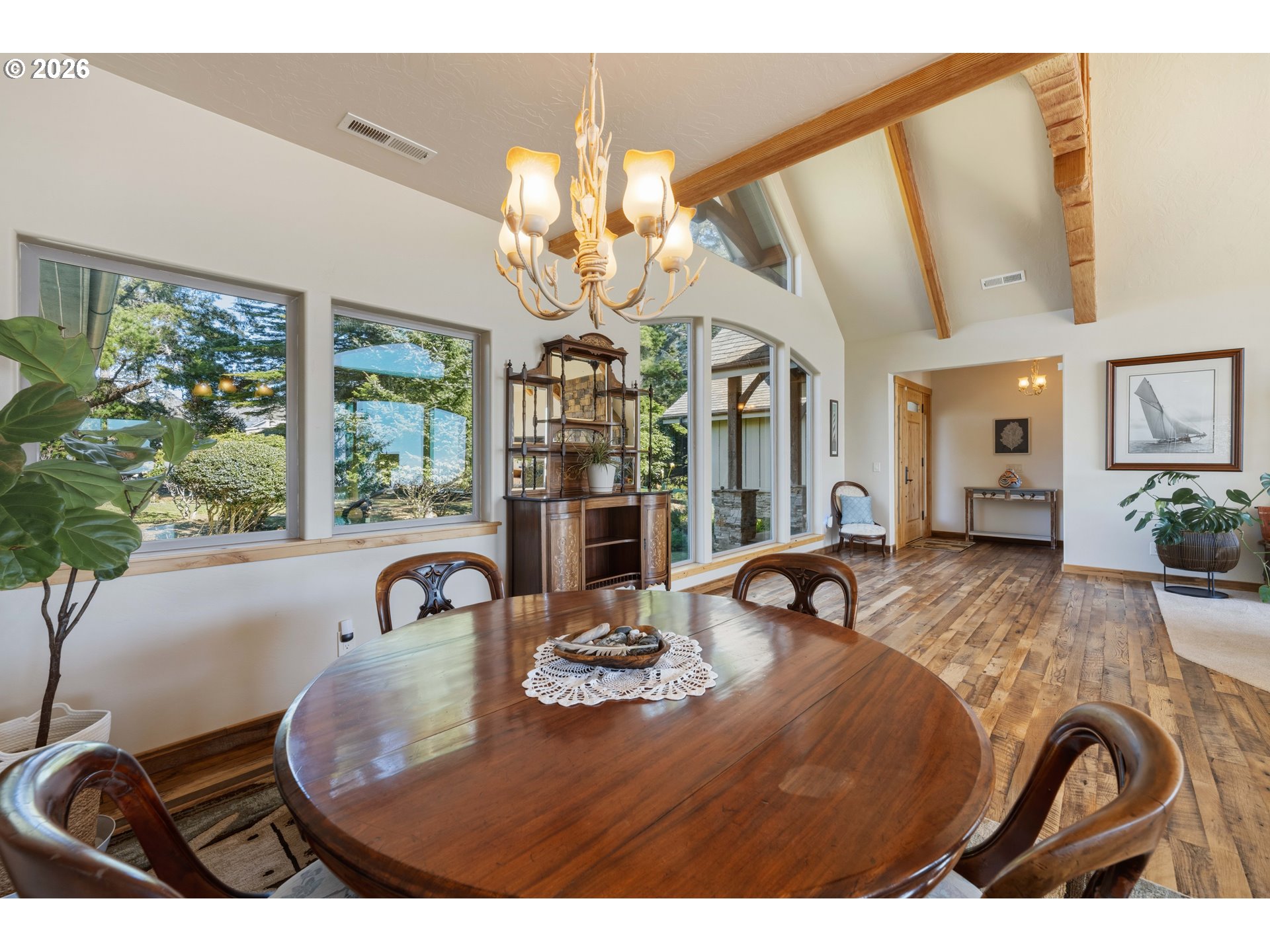 201 Allen Lane Brookings, OR 97415 - Photo 15 of 29 a view of a dining room with furniture a chandelier and large windows