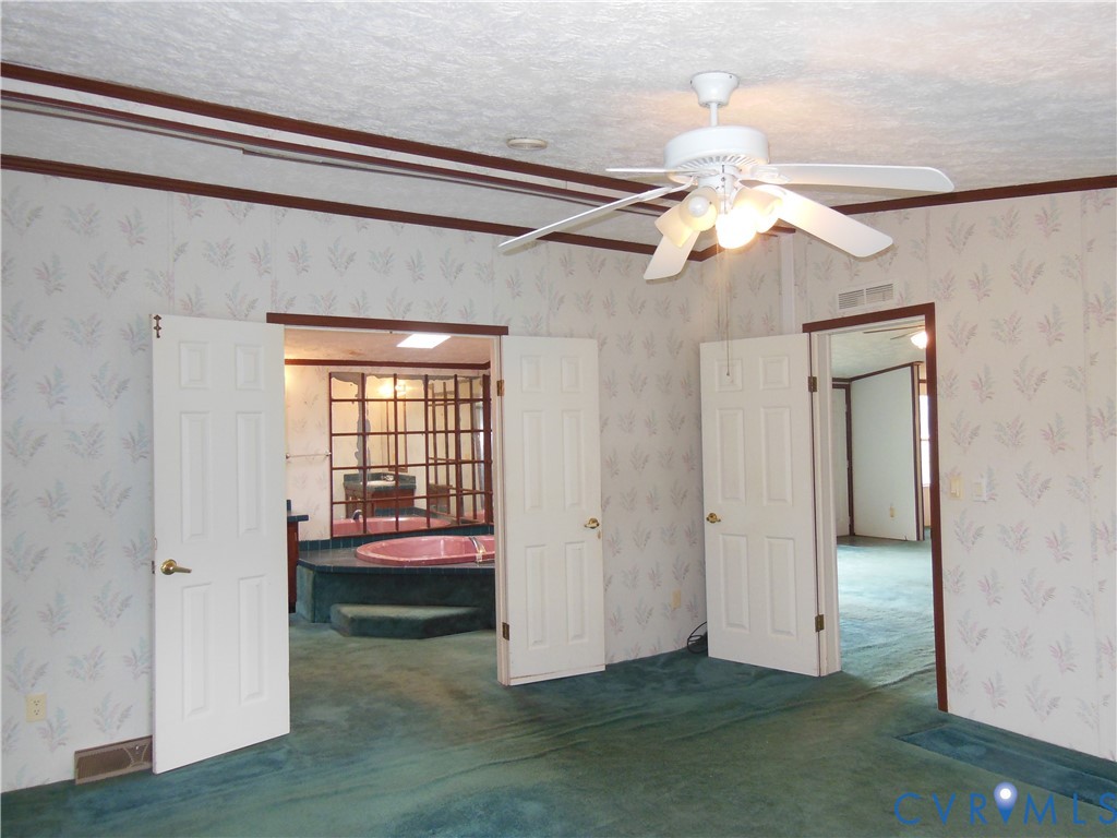 5018 Olgers Road Sutherland, VA 23885 - Photo 15 of 26 a view of bedroom with a ceiling fan and a hardwood floor
