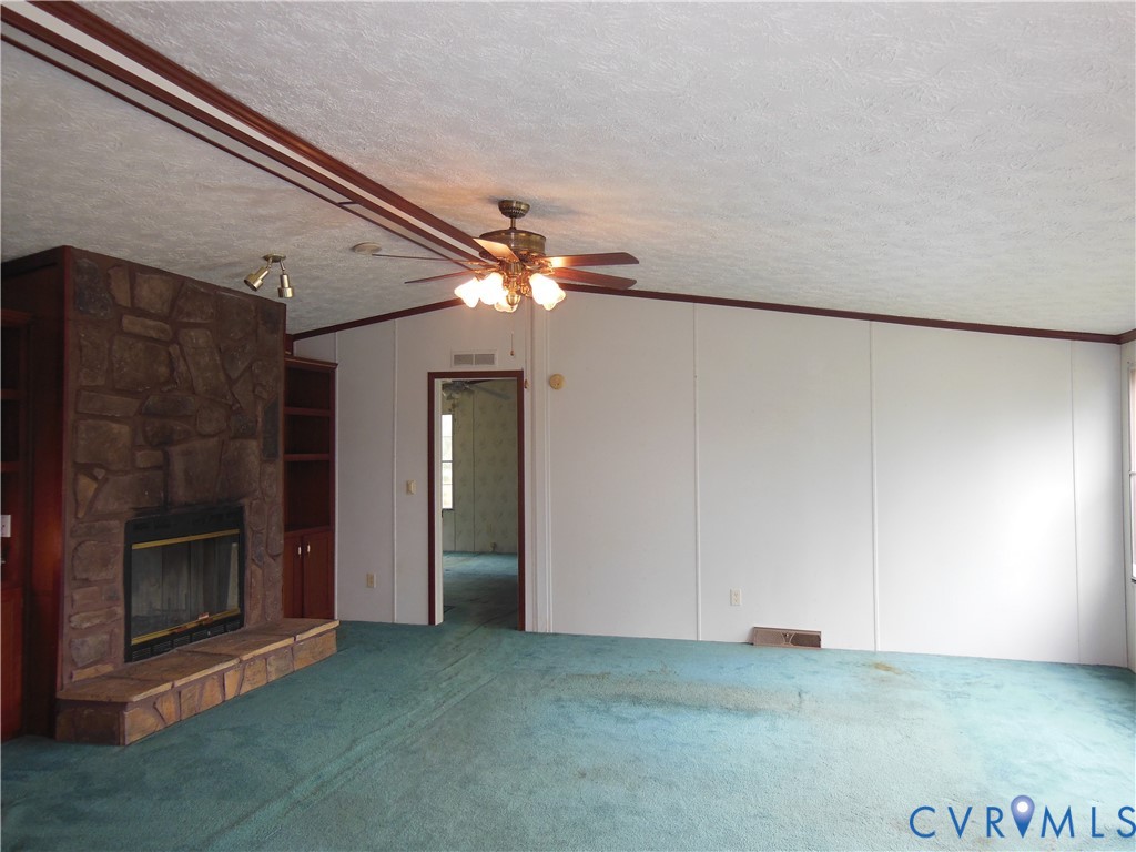 5018 Olgers Road Sutherland, VA 23885 - Photo 8 of 26 a view of a livingroom with an empty space and a fireplace