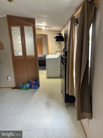 a view of hallway with furniture and a window