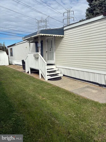 a view of a white house with a yard