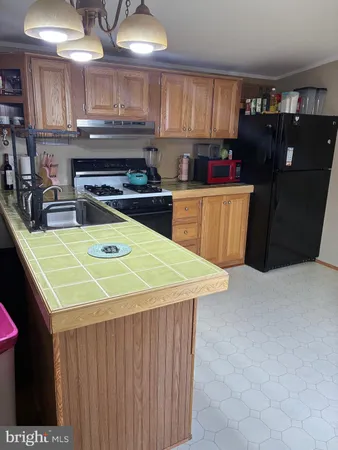 a kitchen with a sink a stove and cabinets