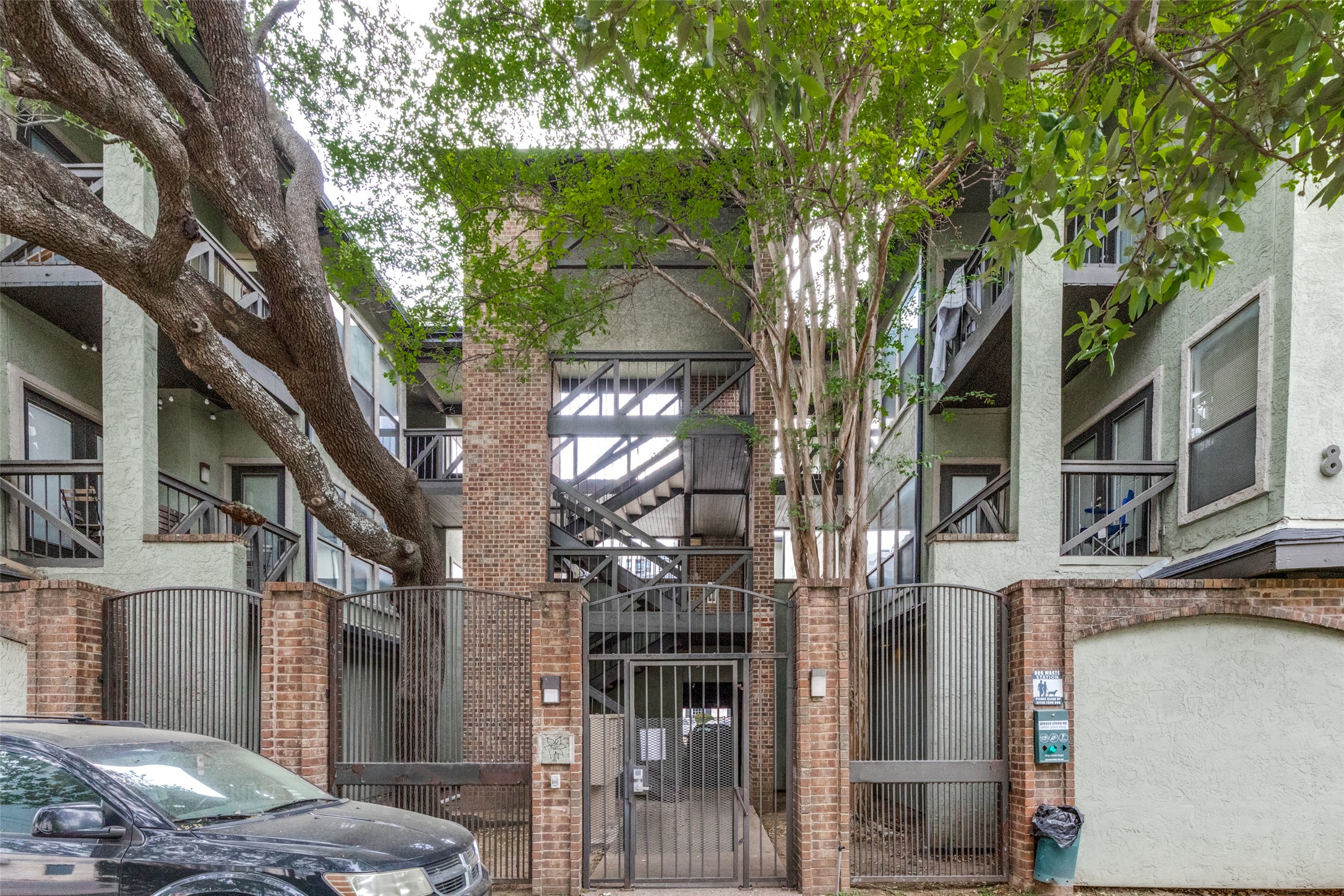 807 West 25th Street, Unit 214 Austin, TX 78705 - Photo 1 of 26 a view of a brick house with a large tree